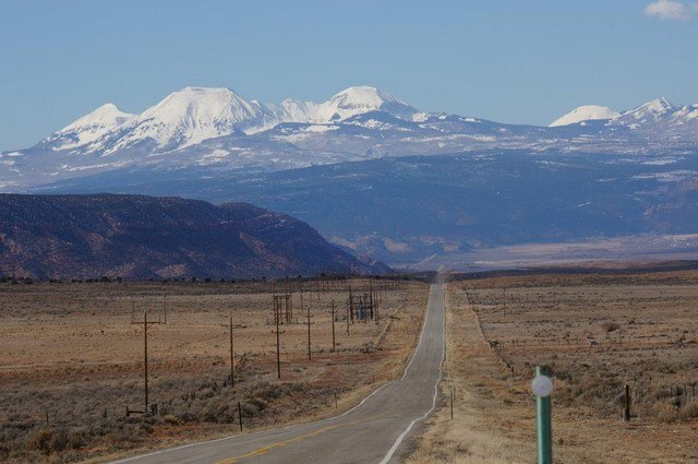 The road stretching to the La Sal Mountains in Utah, near where I got my flat tire.