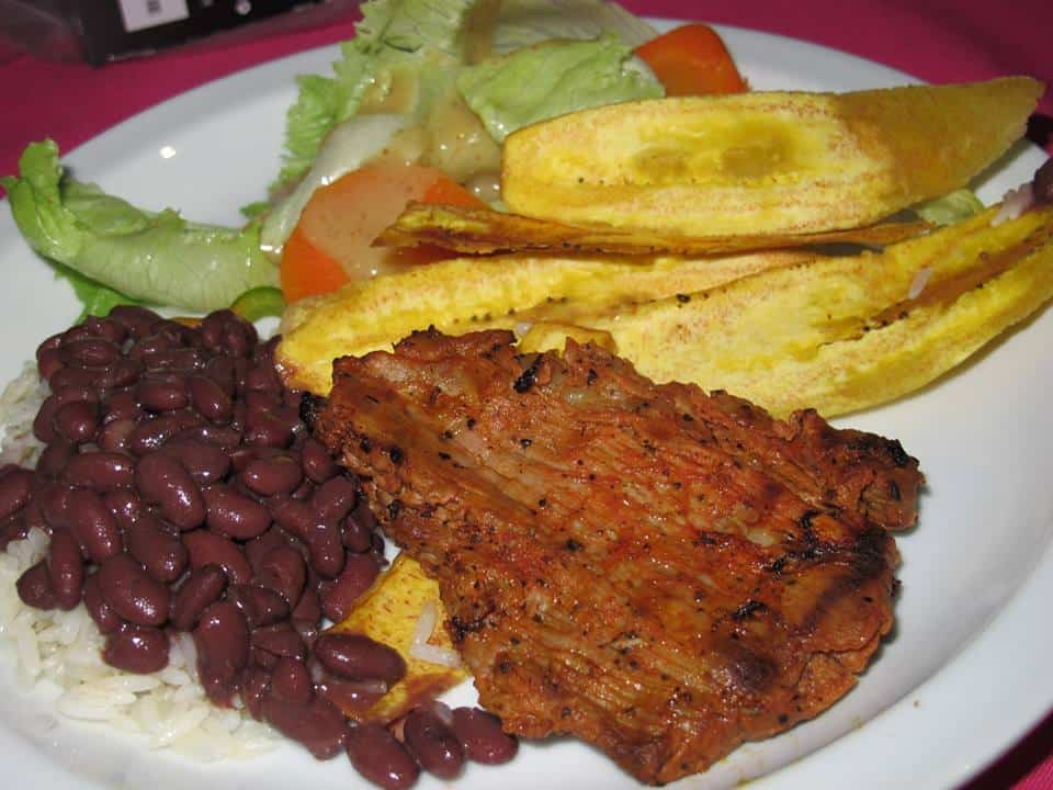 Specially-seasoned Nicaraguan pork with tajadas (fried plantains), rice and beans, salad by the wonderful chefs at Monty's Beach Lodge