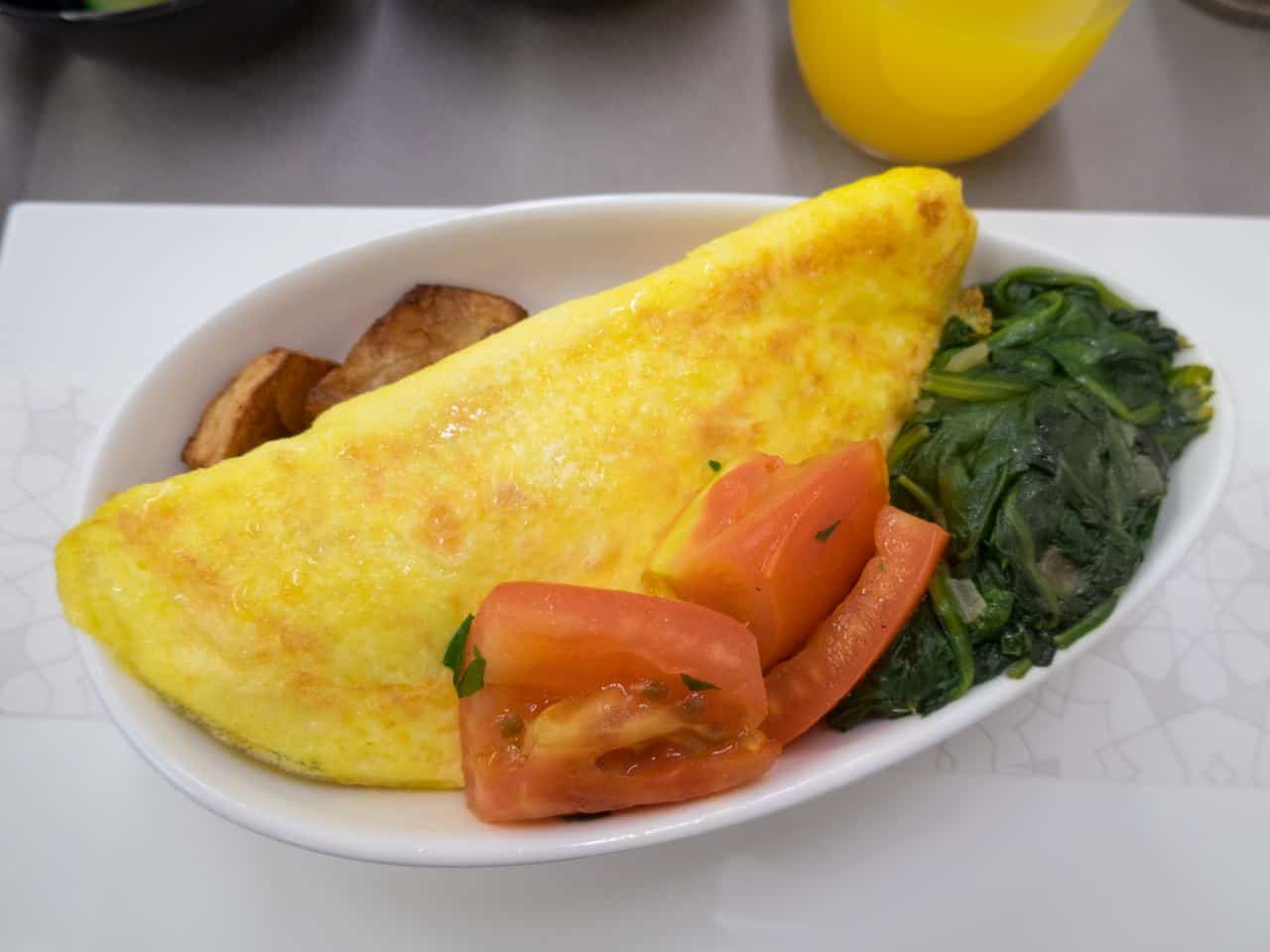 Omelet with potatoes, tomatoes and spinach