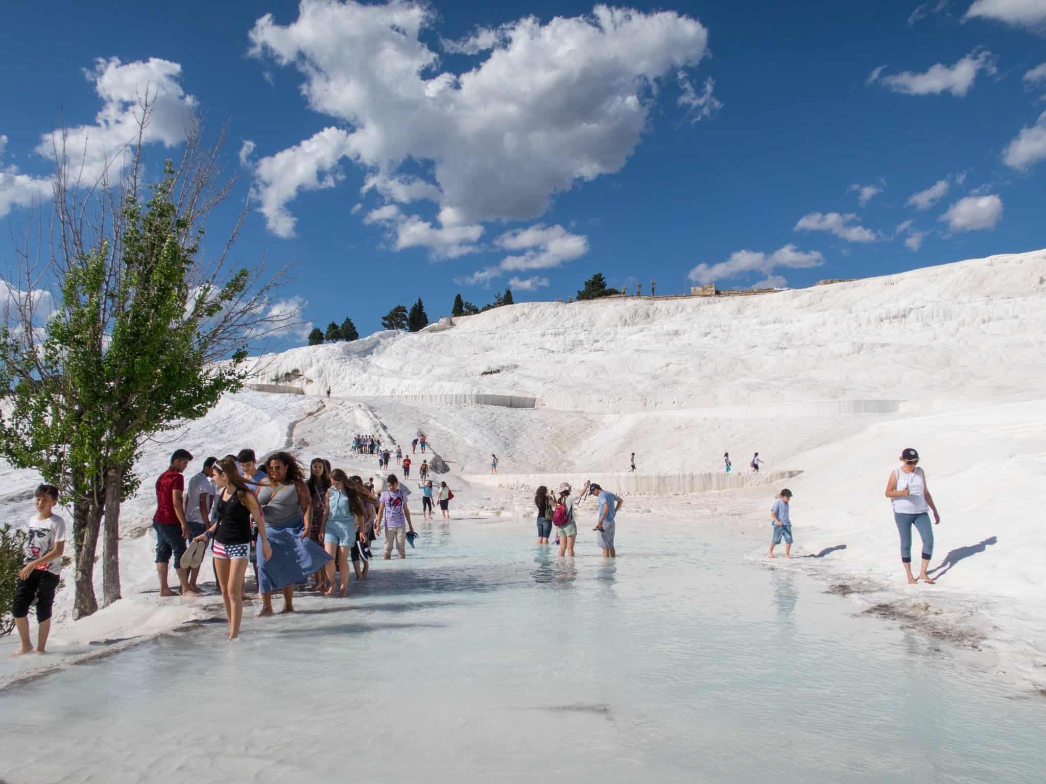 Visitors wade in a pool.