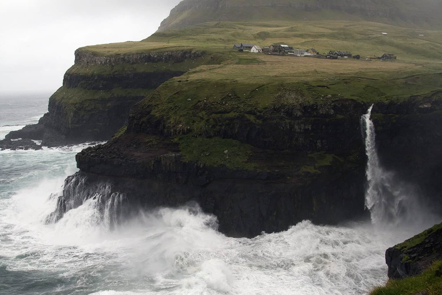 The small town of Gàsadalur, made famous by its waterfall. 