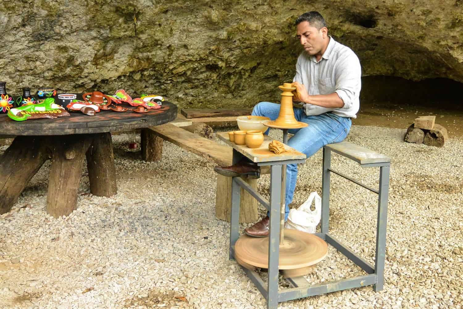 A potter from Chiapas demonstrates the traditional technique of foot-powered, hand-thrown pottery