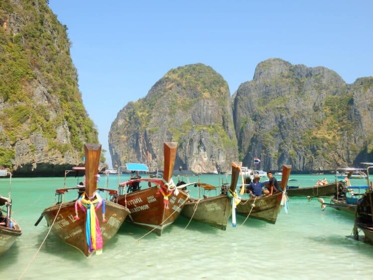 Longboats in Maya Bay, Thailand before it was closed due to overtourism