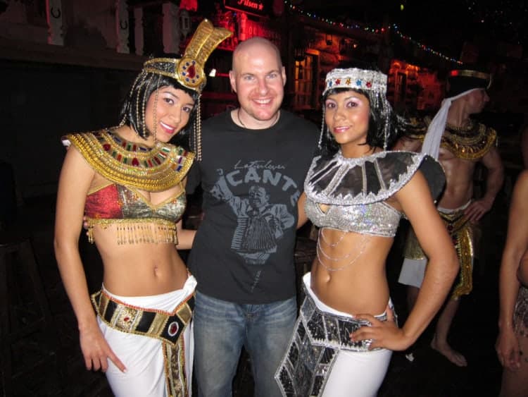 Dave has his picture taken with dancers at a club in Medellin