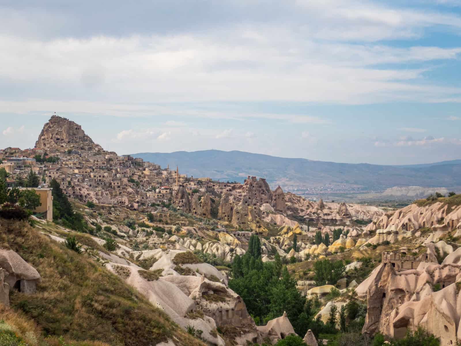 Visiting the rock castle at Uchisar (far left) is one of the most interesting things to do in Cappadocia