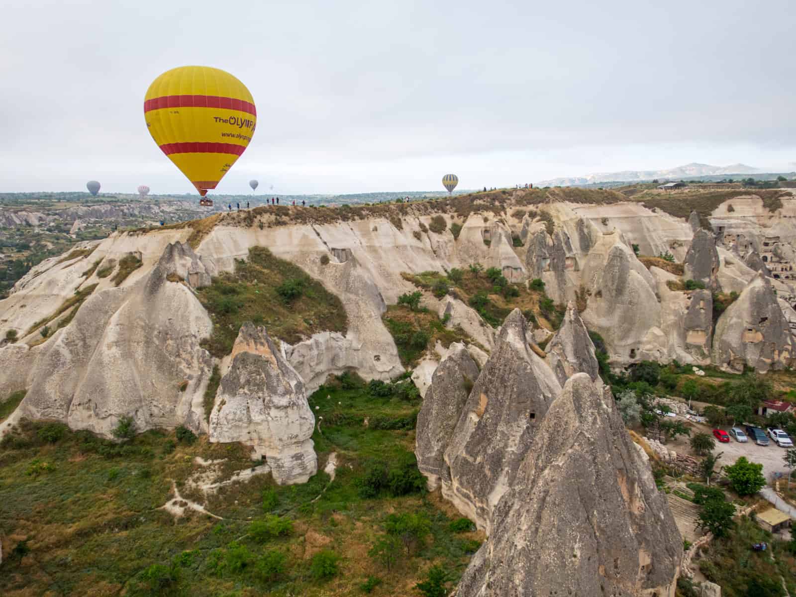 A balloon flies by a scenic outlook