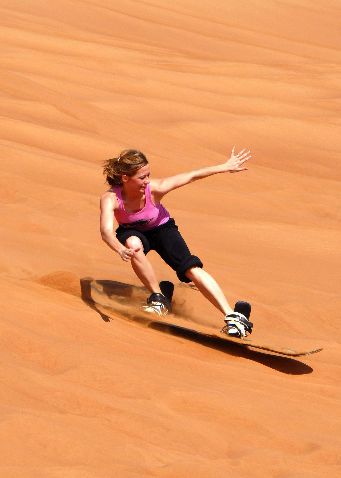 Woman sandboarding in Dubai