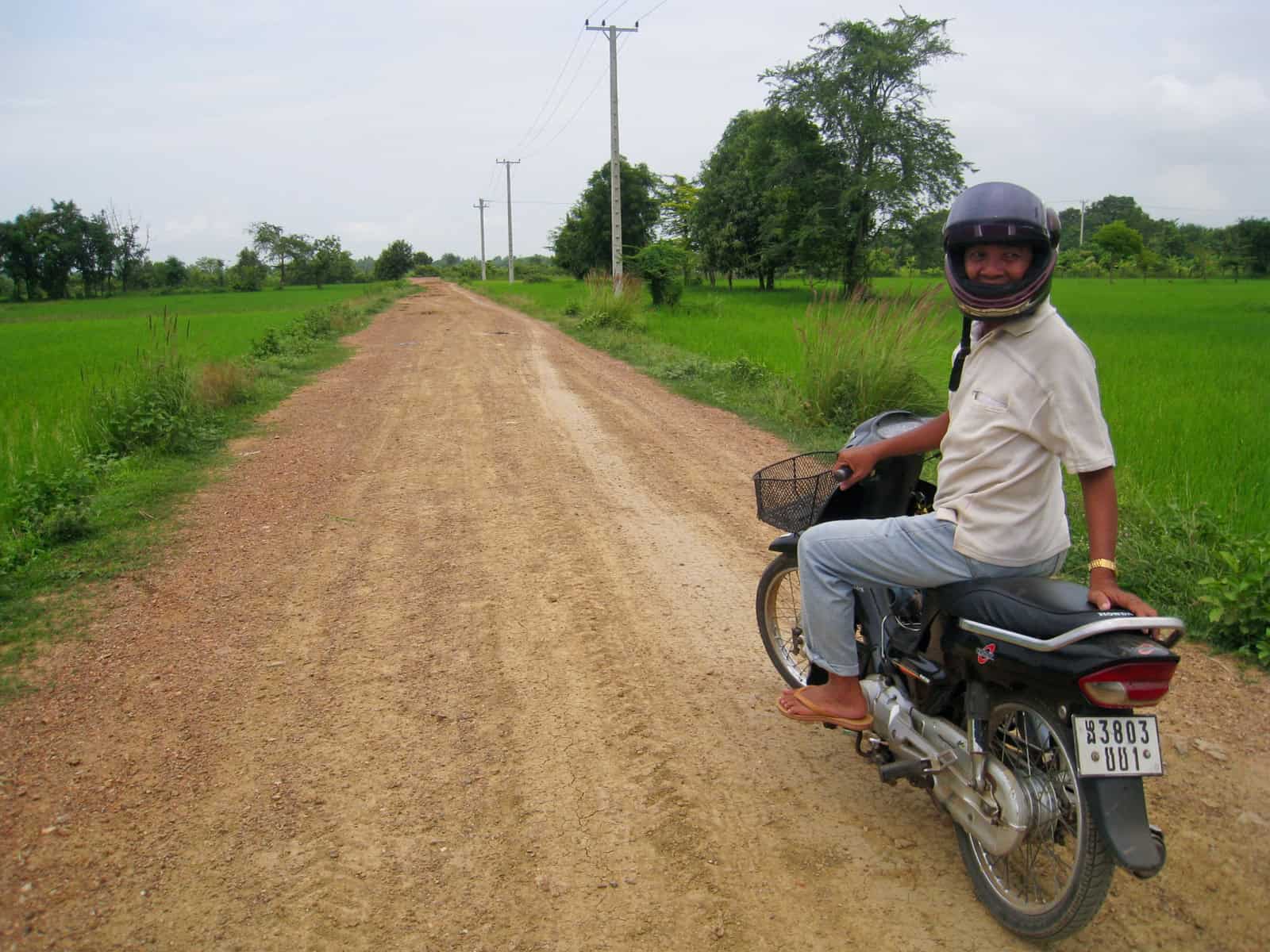 Phi-Lay, my Cambodian guide, on his motorbike outside Battambang