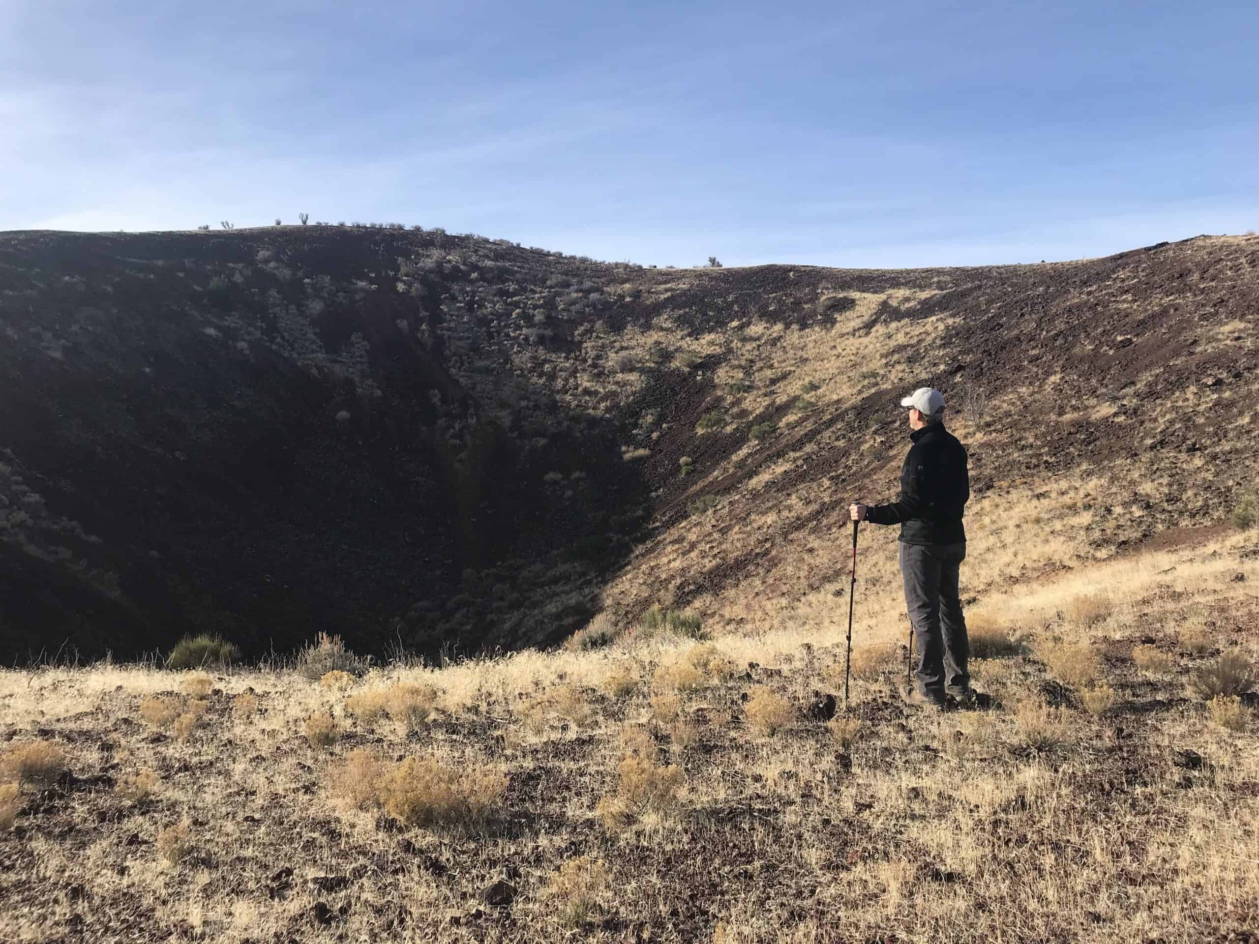 Standing on a volcano crater rim during a road trip to Zion National Park.