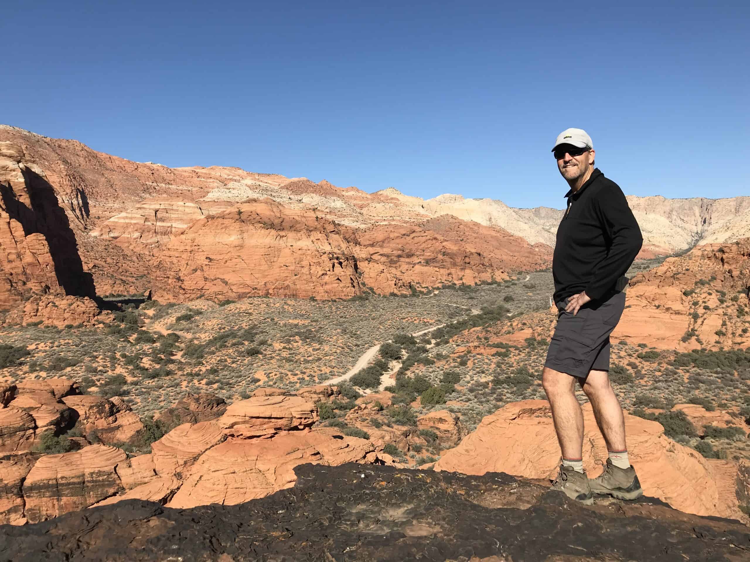 The author smiling amid the beautiful landscape.