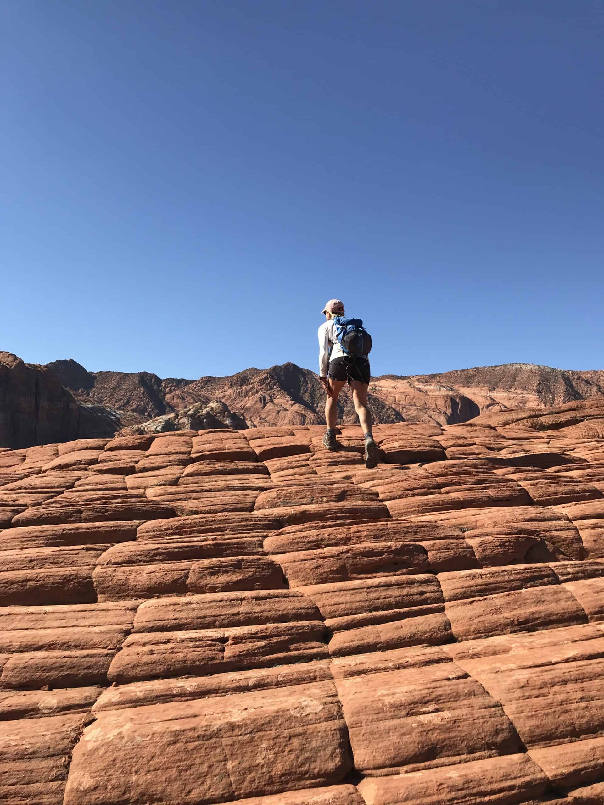 Hiking red sandstone on a road trip to Zion National Park.