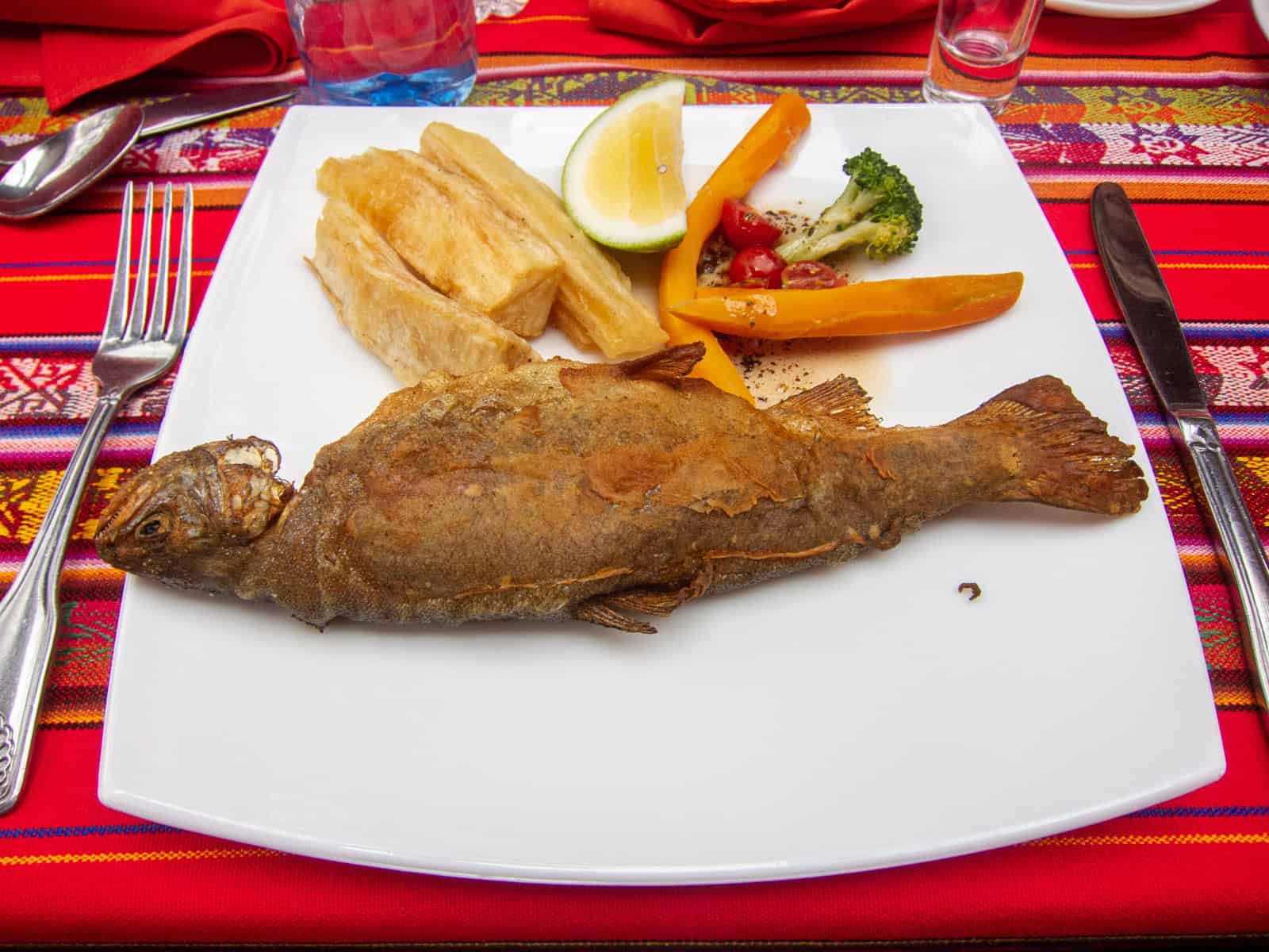 Fried Trucha with yuca and vegetables is a common Ecuadorian food.