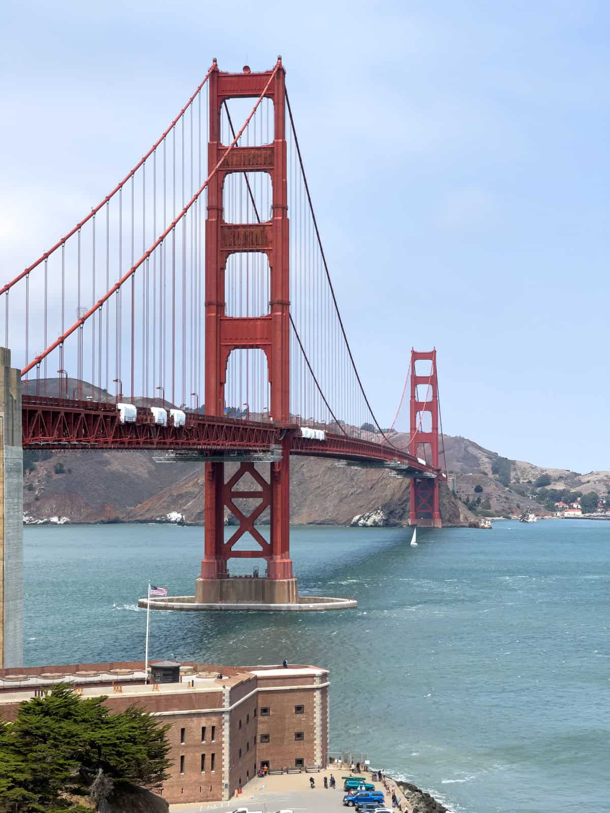 The Golden Gate Bridge towers over a  Civil War fortress below it.