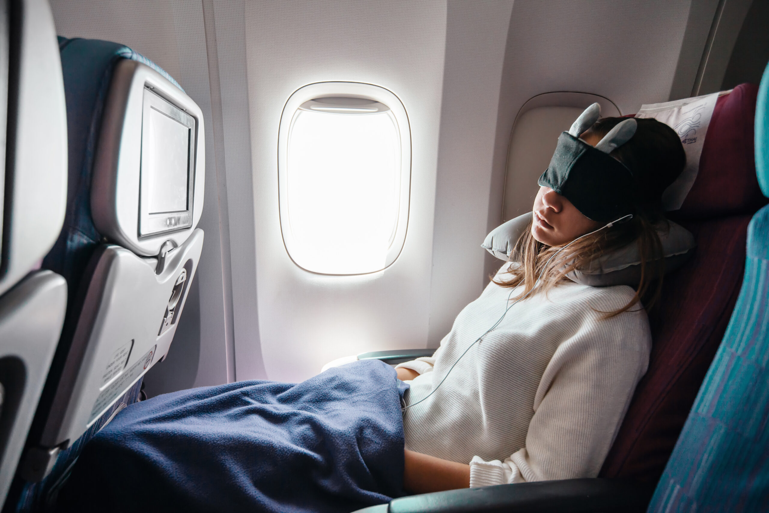 A woman sleeps on a flight