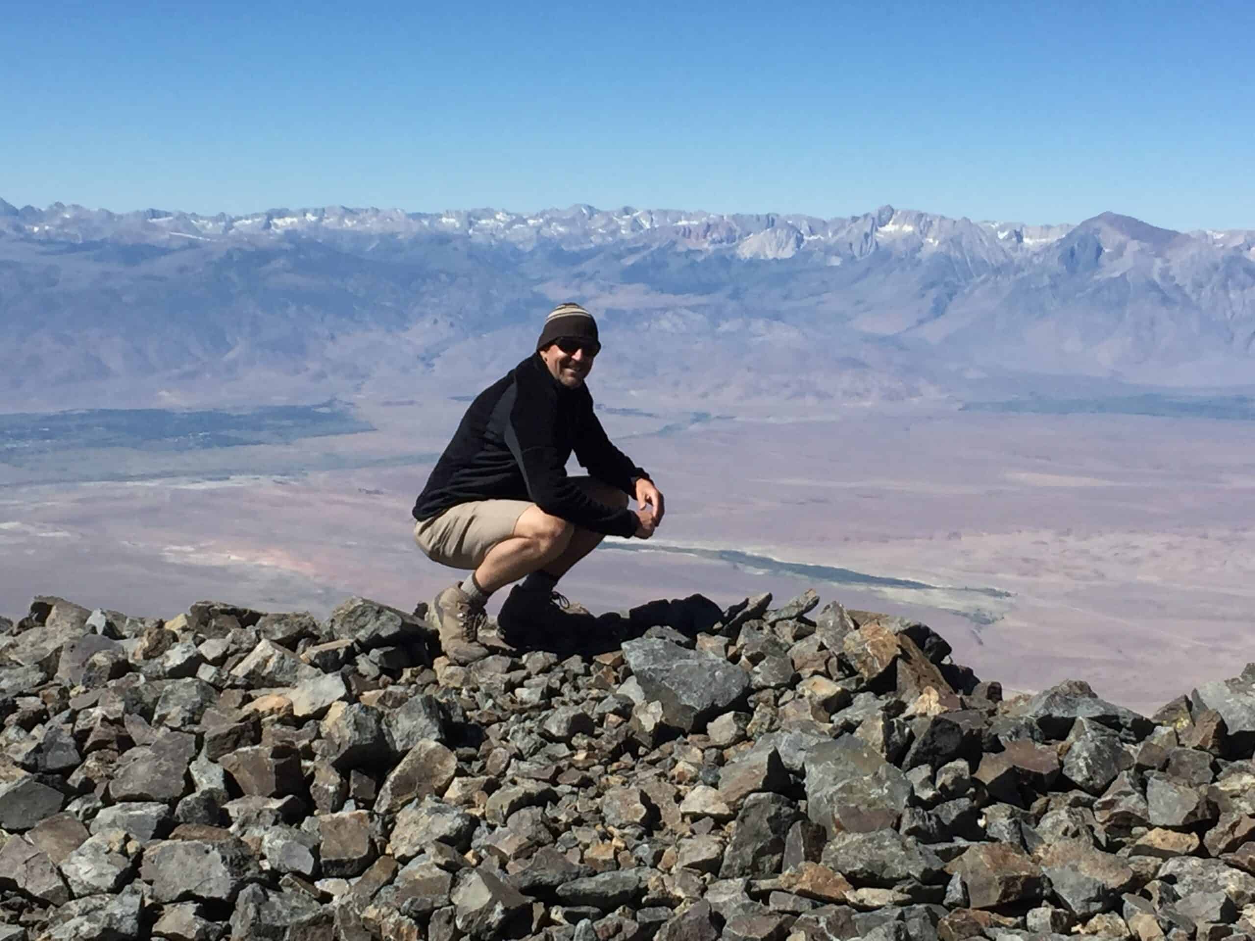 Smiling for a photo atop 14,252 feet (4,344 meters) White Mountain Peak in the Sierra Nevada mountains