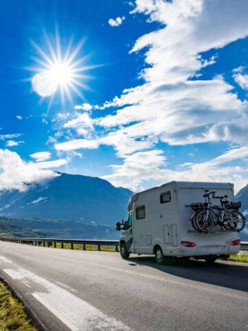An RV driving on a mountain road.