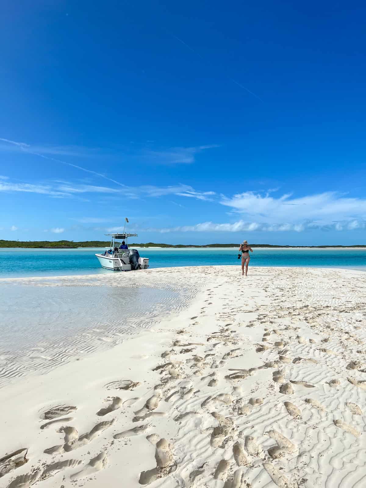 Kelly walking on a sand bar at low tide in The Exumas, The Bahamas