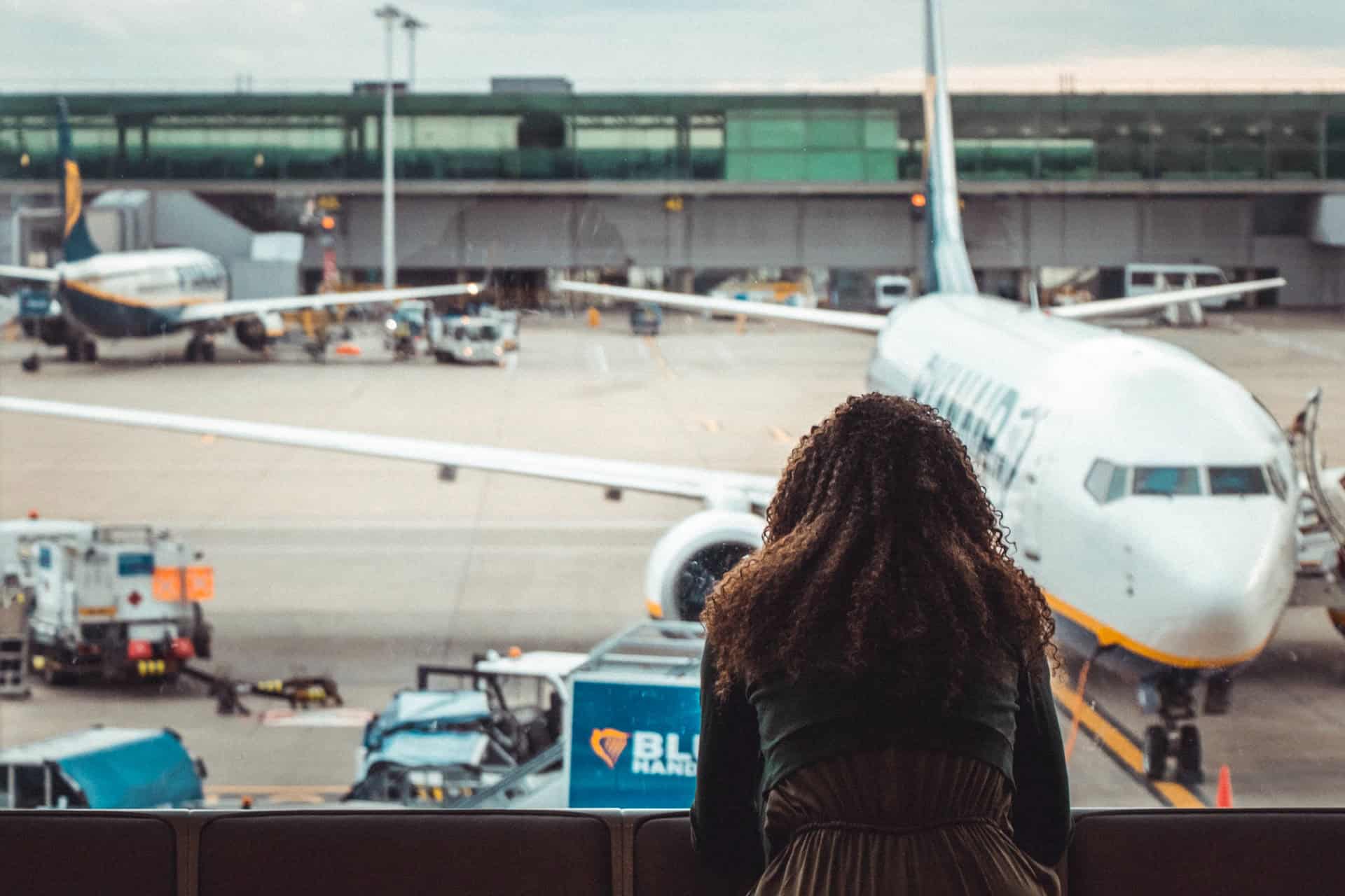 Woman in an airport contemplating the best CBD products for travel. (photo: Arthur Edelmans)