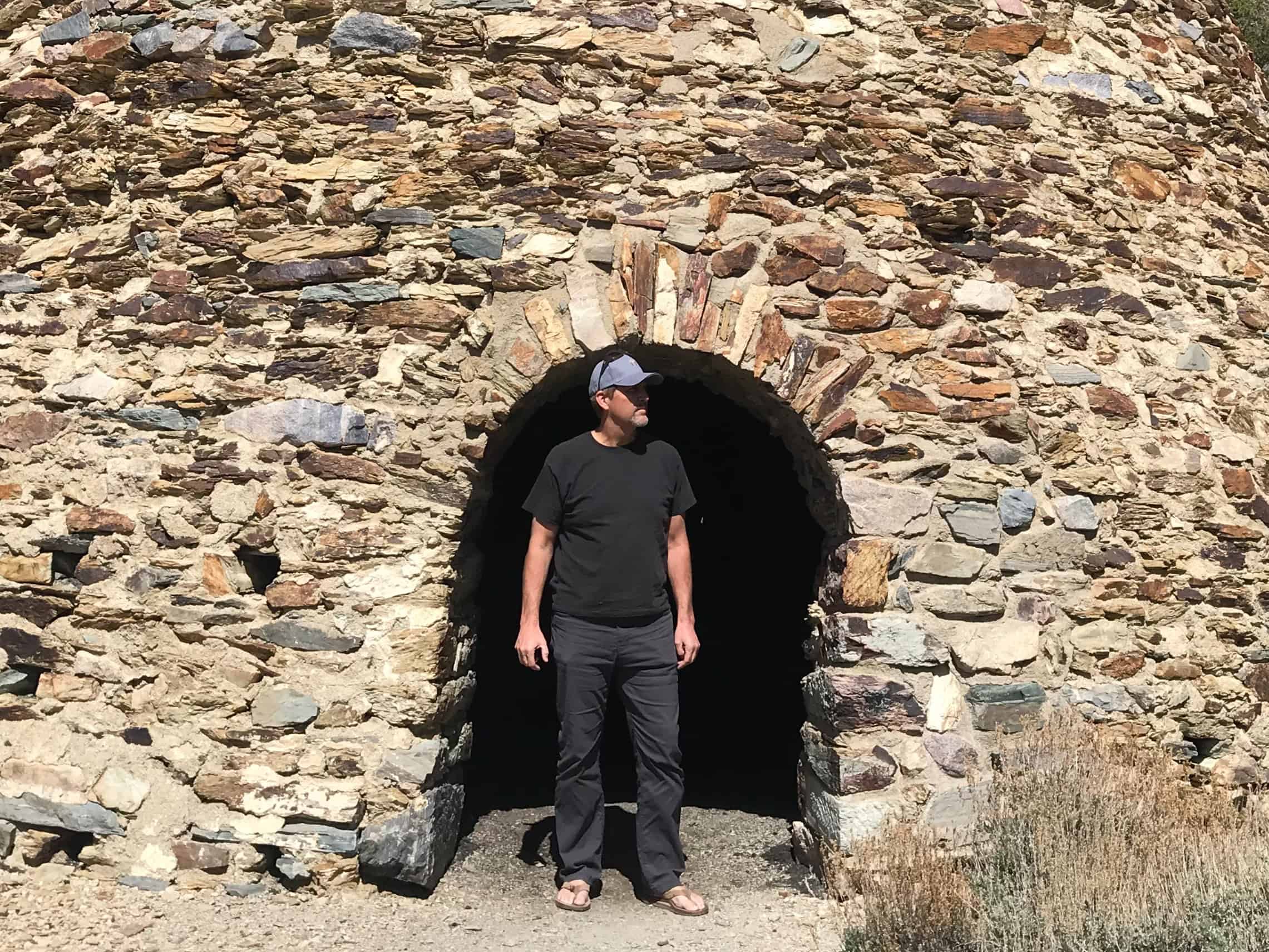 The author standing in the entrance to an old charcoal kiln.