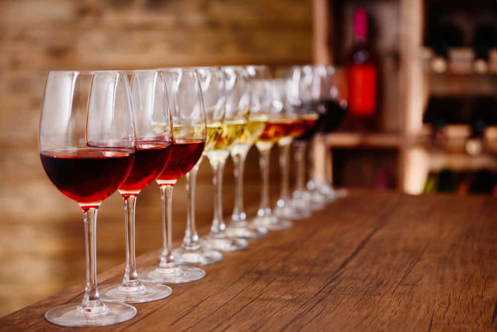 Many glasses of different wine in a row on bar counter | Miramonte Winery