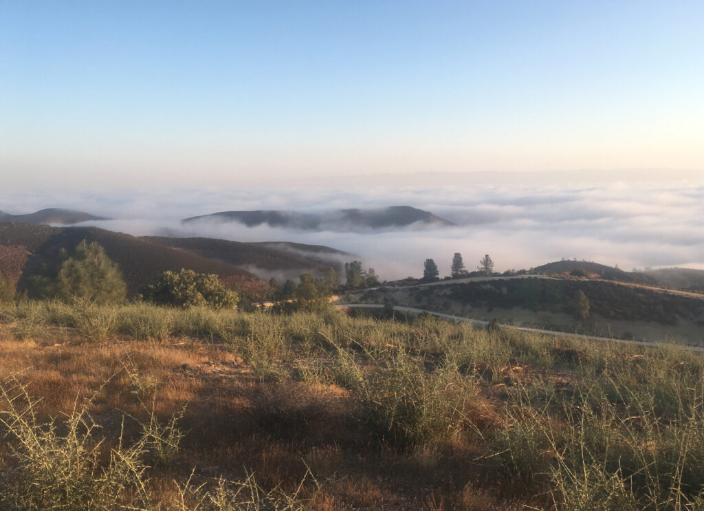 view of hilly landscape among the clouds