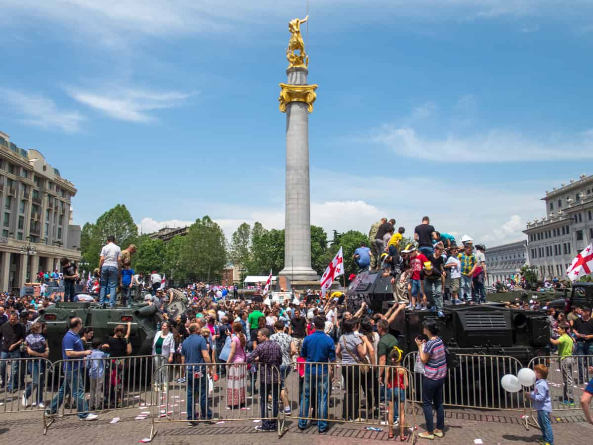 Kids climb on military vehicles during Georgia's Independence Day celebrations in Freedom Square