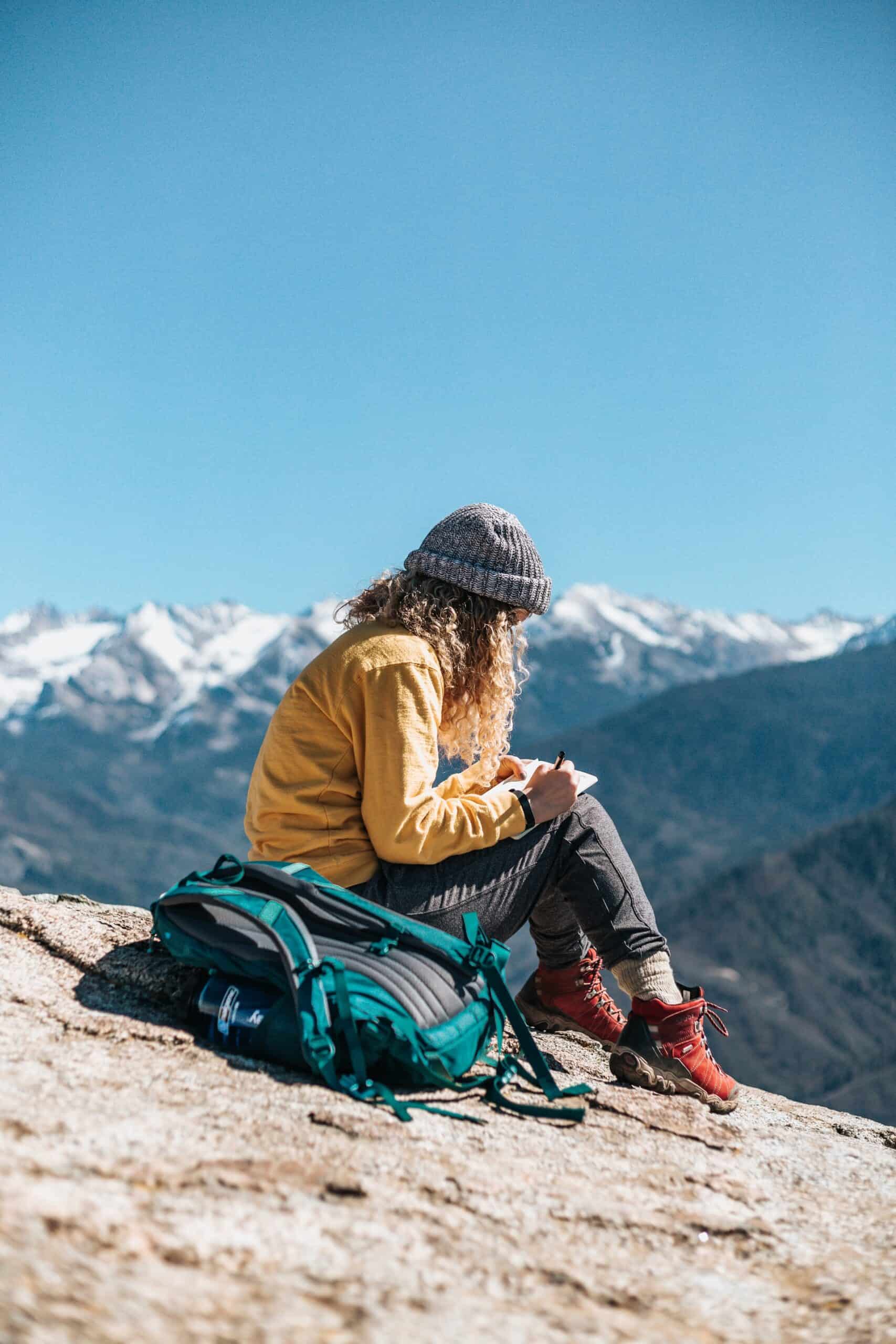 A hiker journaling in the mountains (photo: Tyler Nix)