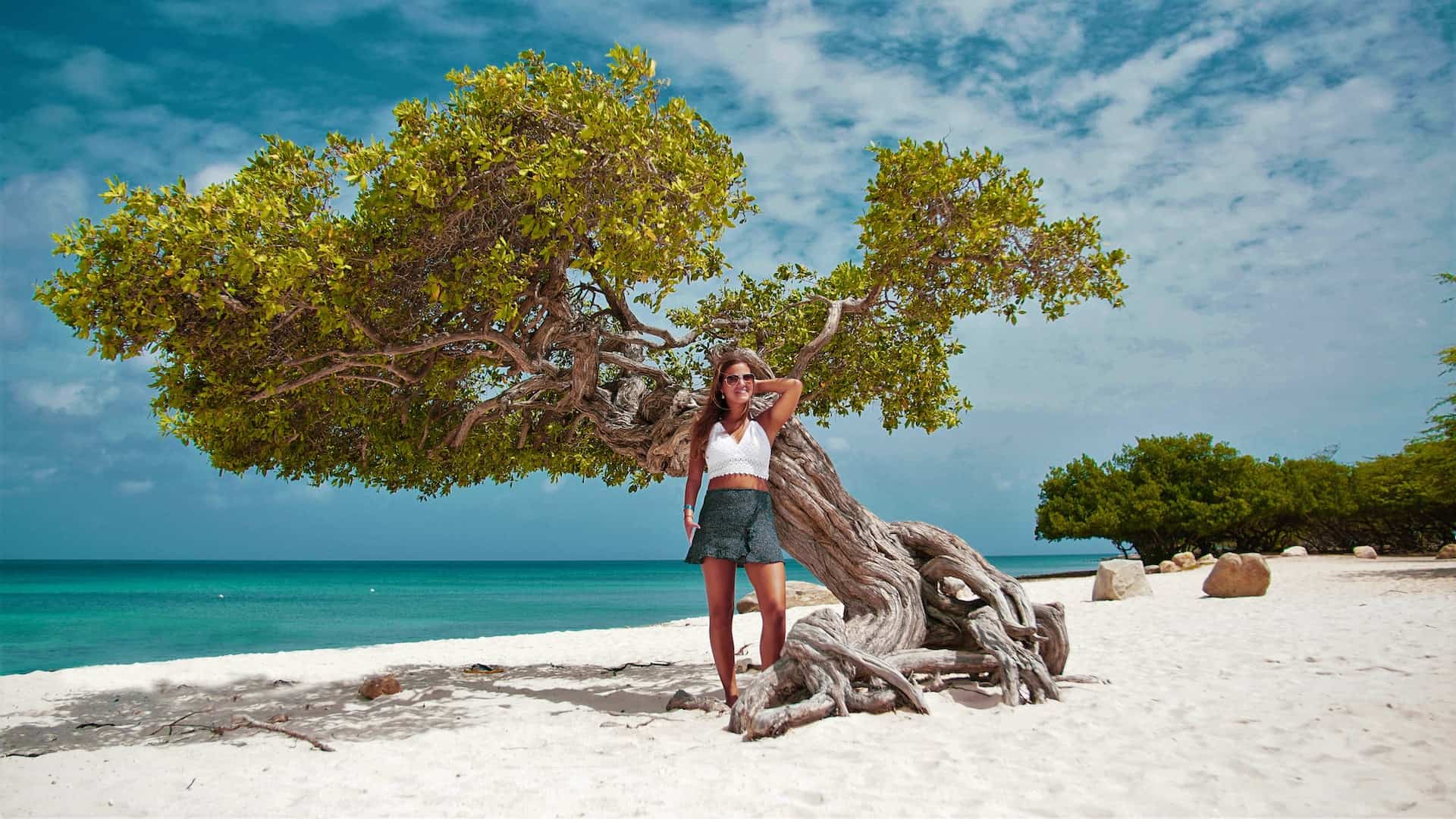 Woman posing on Eagle Beach which is home to one of the best Aruba all inclusive resorts (photo: Brian Tromp)