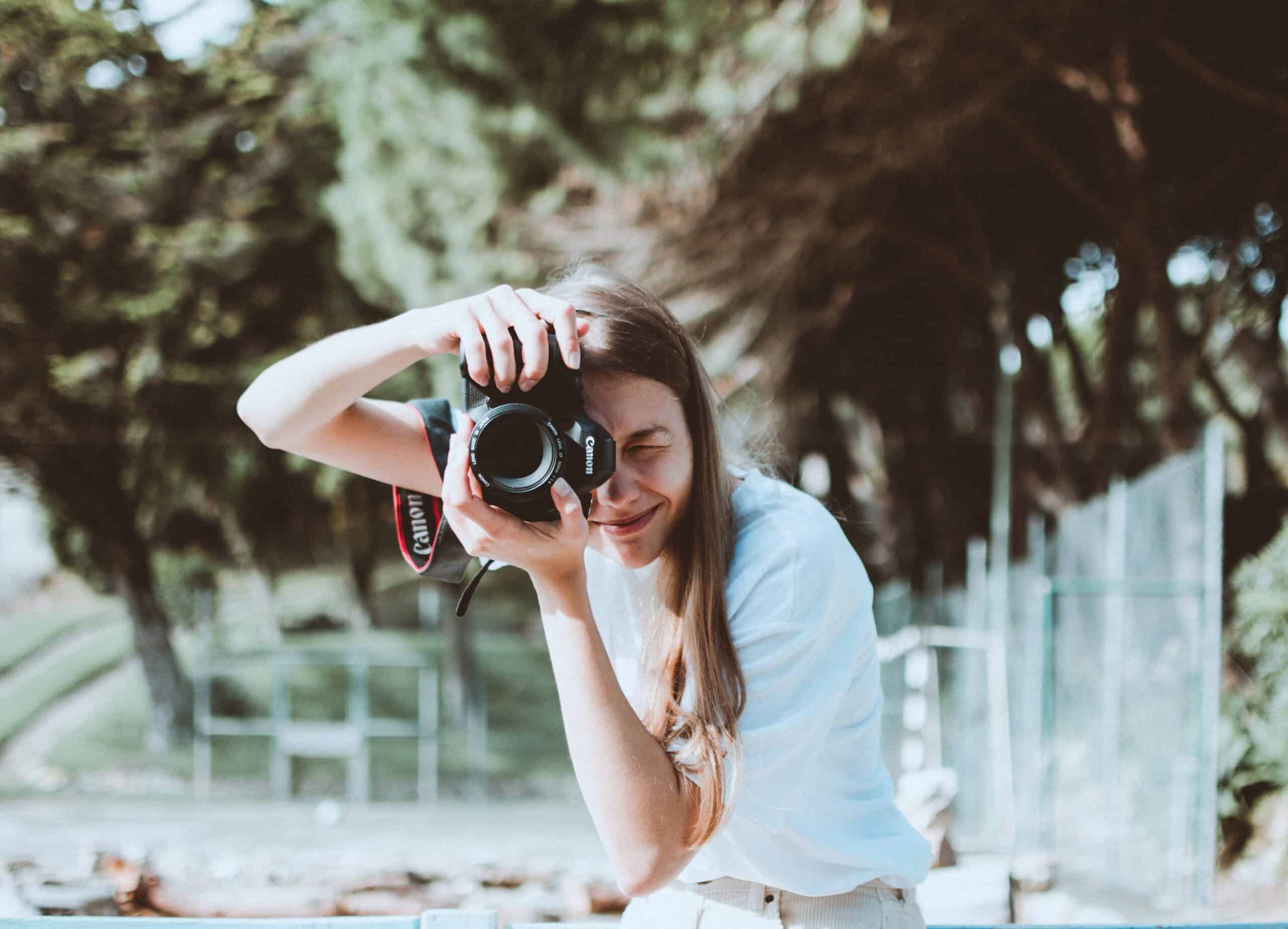 A woman practicing her travel photography with a Canon DSLR camera (photo: Lisa Fotios)