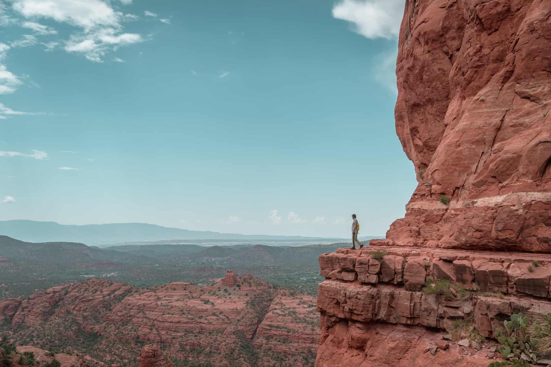 Man on a narrow ledge (photo by Tommy Tang)