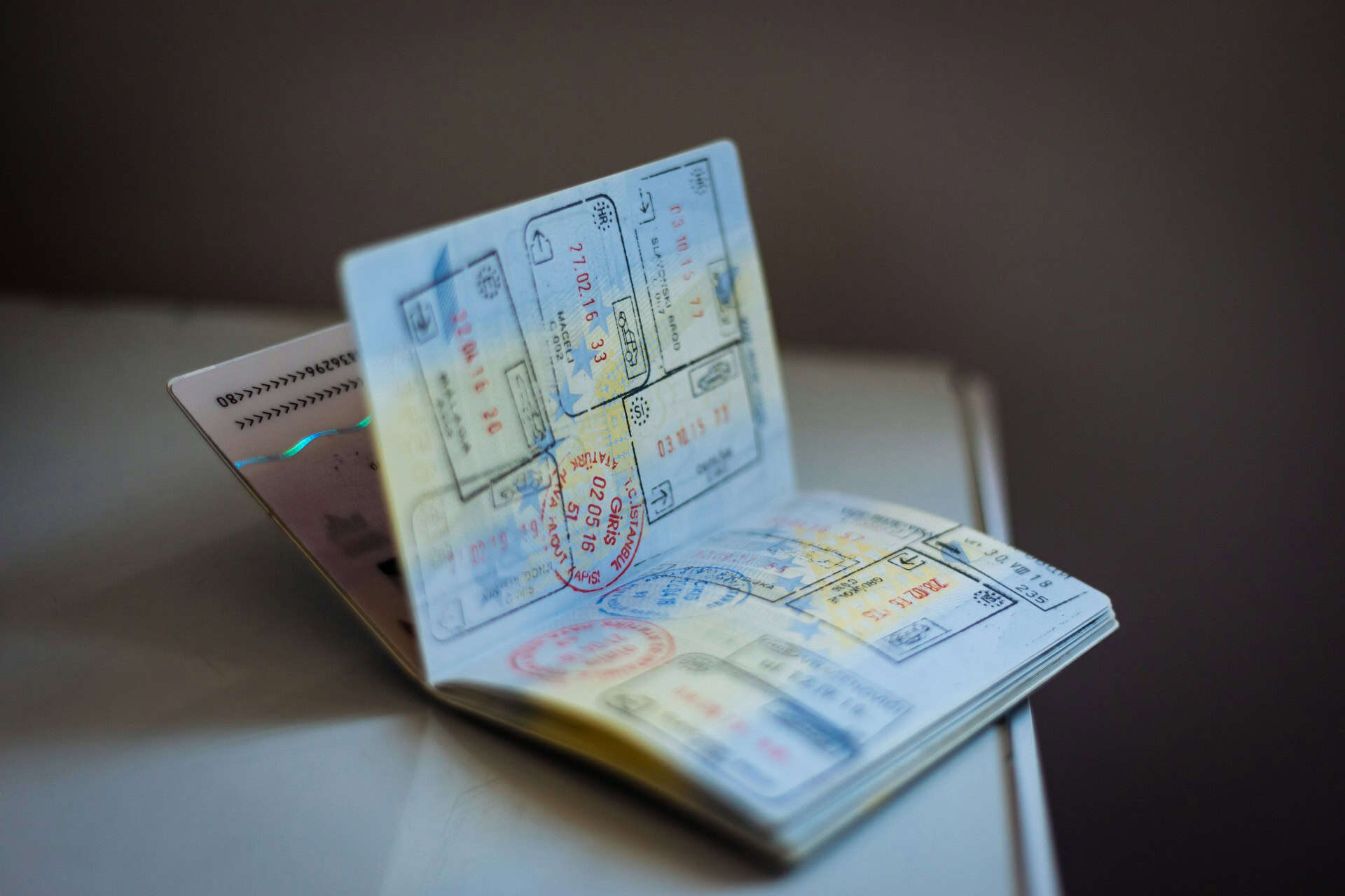 Visa stamps passport (photo by Global Residence Index, Unsplash).