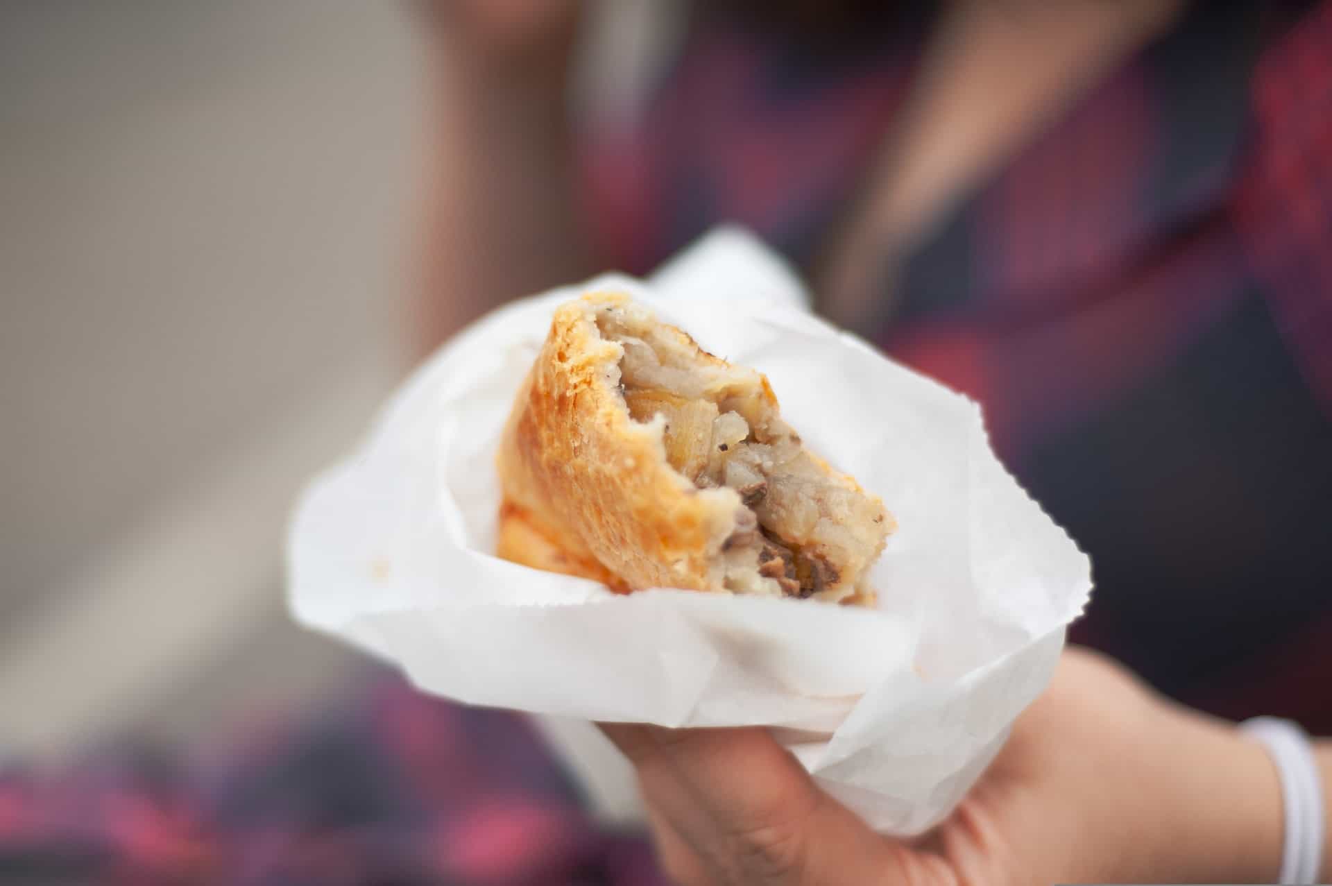 A woman eating a Cornish pasty, a typical English food (photo: Harry Grout)