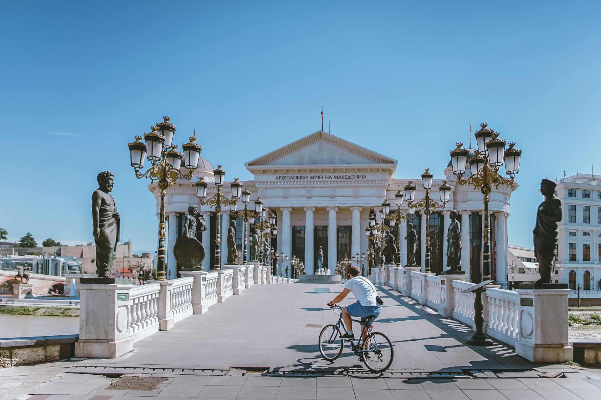 A man on a bicycle rides over a bridge in Skopje, Macedonia (photo: Toa Heftiba)