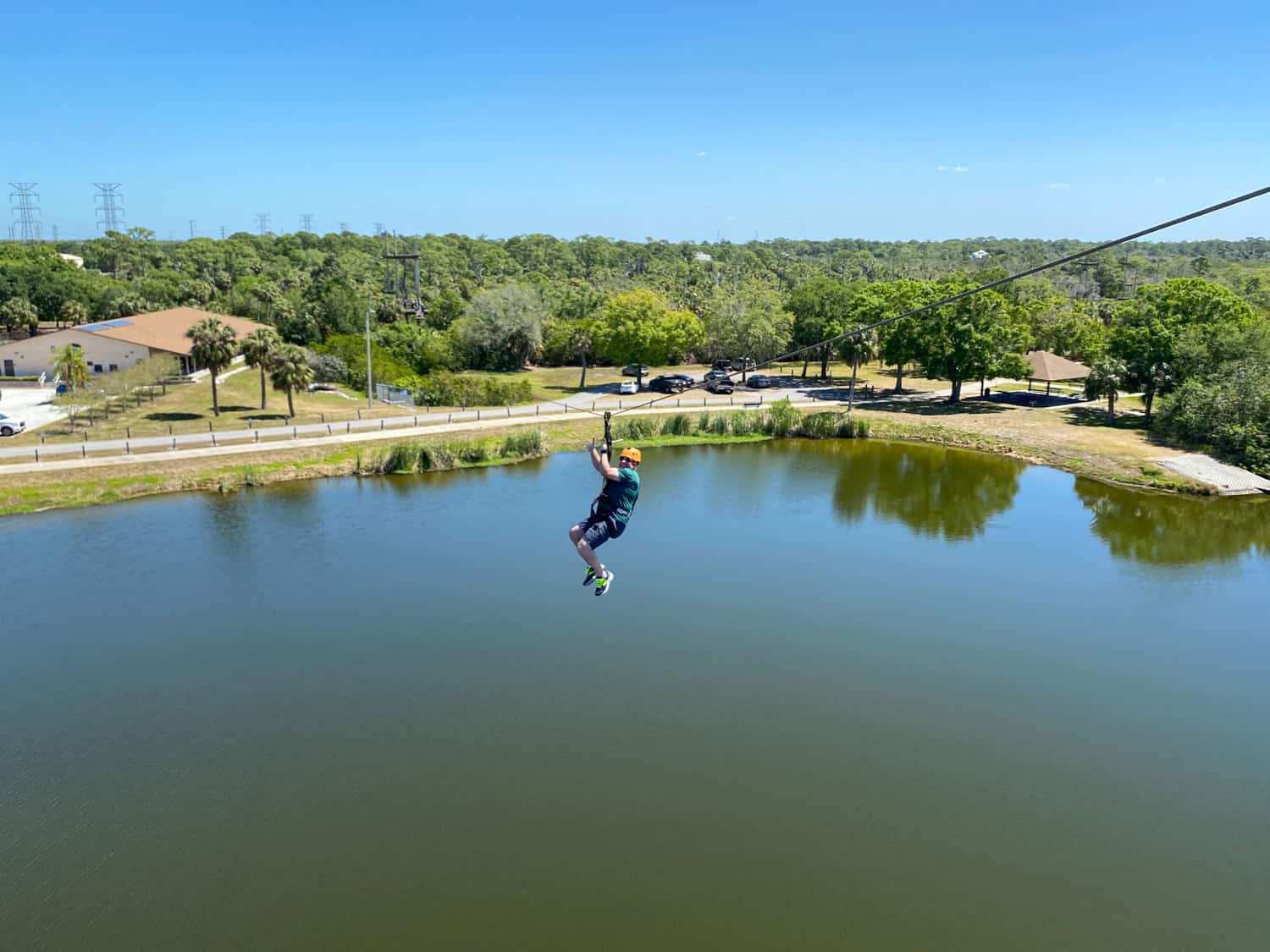 Dave attempting to pose for a photo while zipling over water