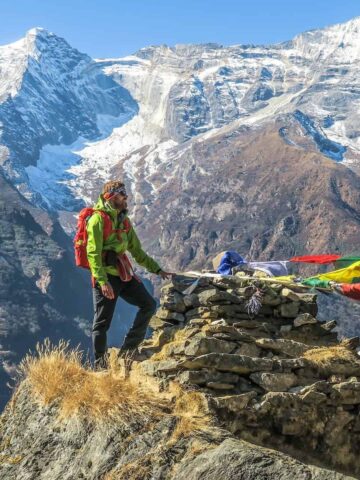 Hikers and Tibetan prayer flags in Namche Bazaar (photo: Sebastian Pena Lambarri).