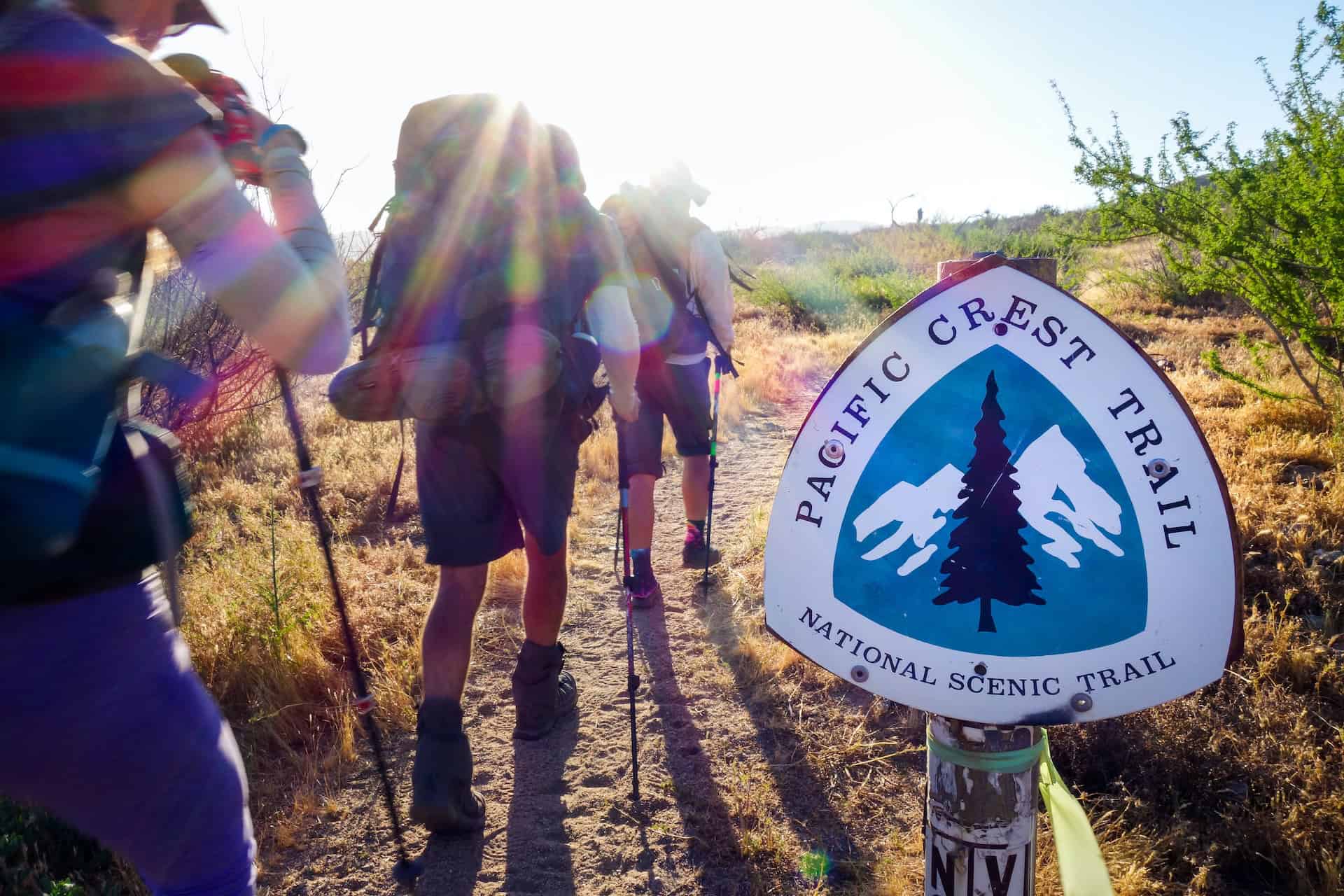 Hikers pass a Pacific Crest Trail sign (photo: Sebastien Goldberg)