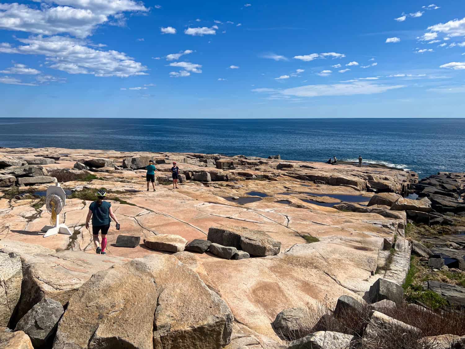 Walking on the rocky coastline of Schoodic Point in Acadia National Park, ME