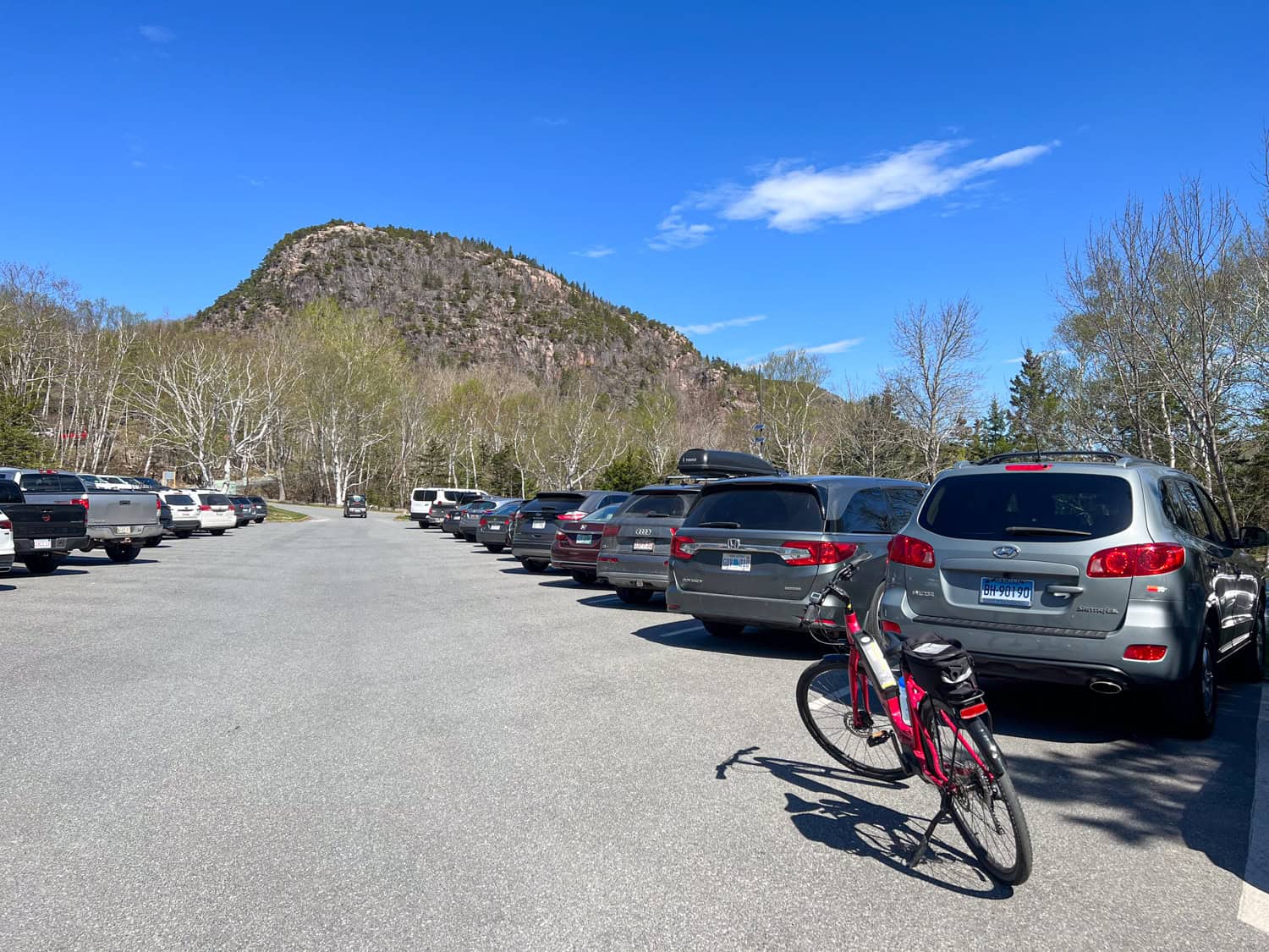 Sand Beach parking lot and a view of Beehive Trail on the mountain in the back.