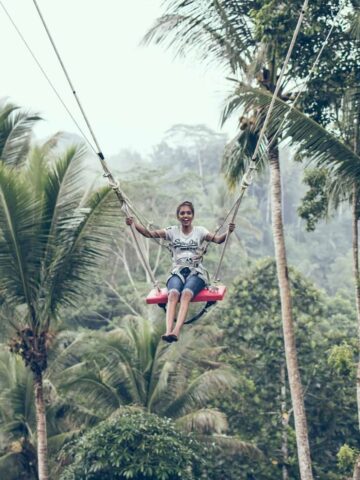 A woman swinging in Bali (photo: Artem Beliaikin).