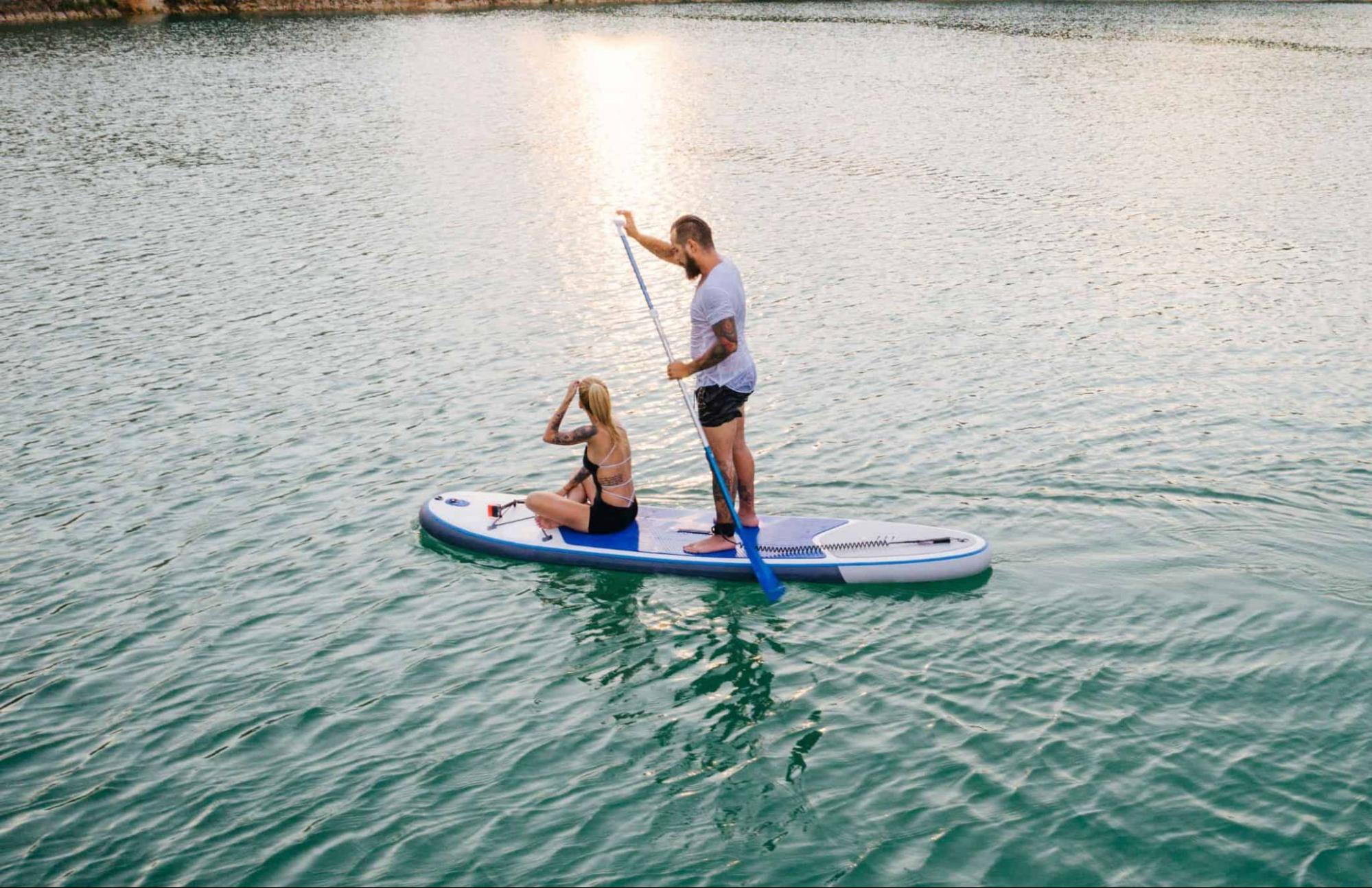 Couple paddleboarding (photo: Getty Images Signature via Canva Pro)