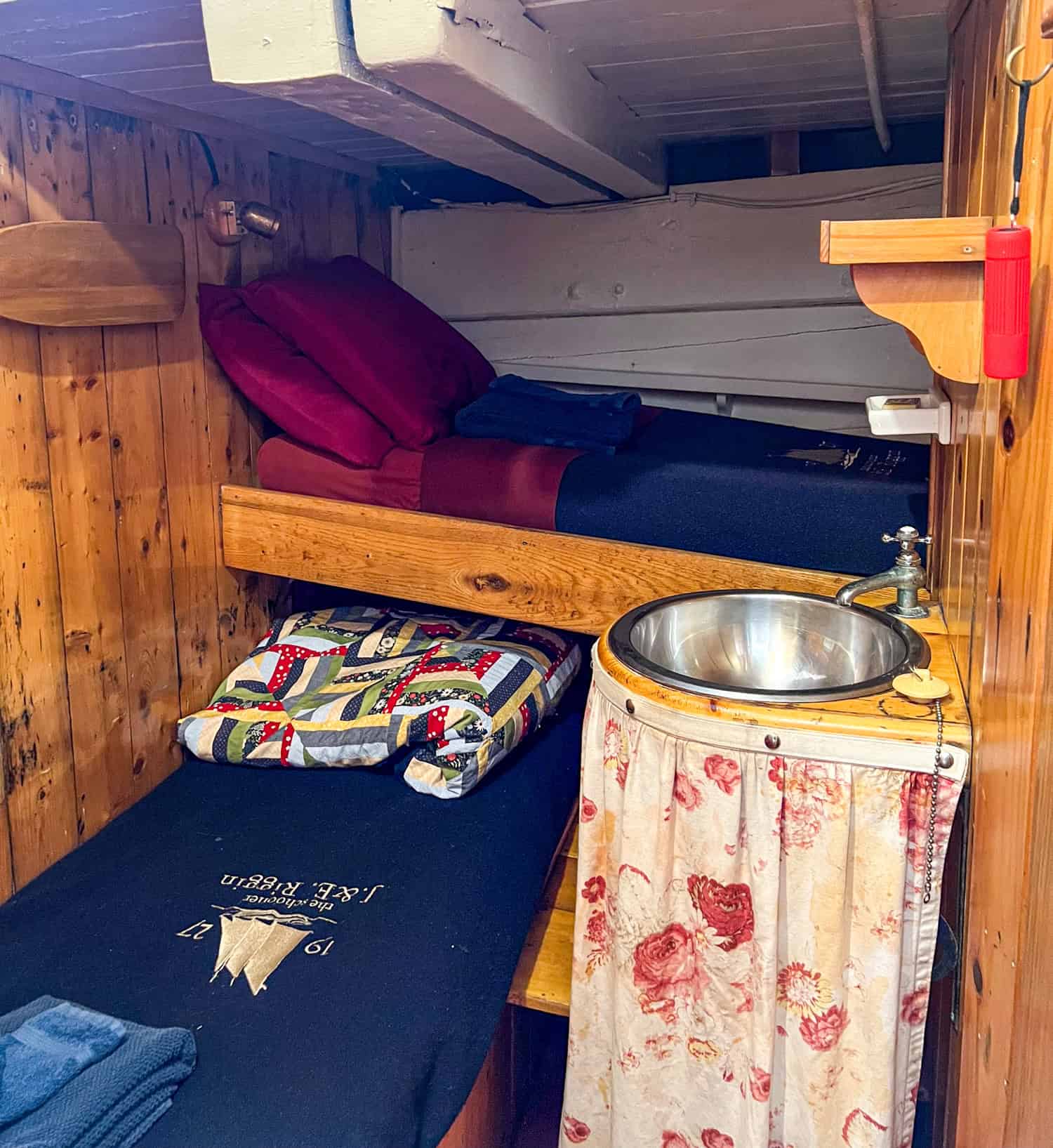 Two single beds and a sink in cabin #3 on the J & E Riggin