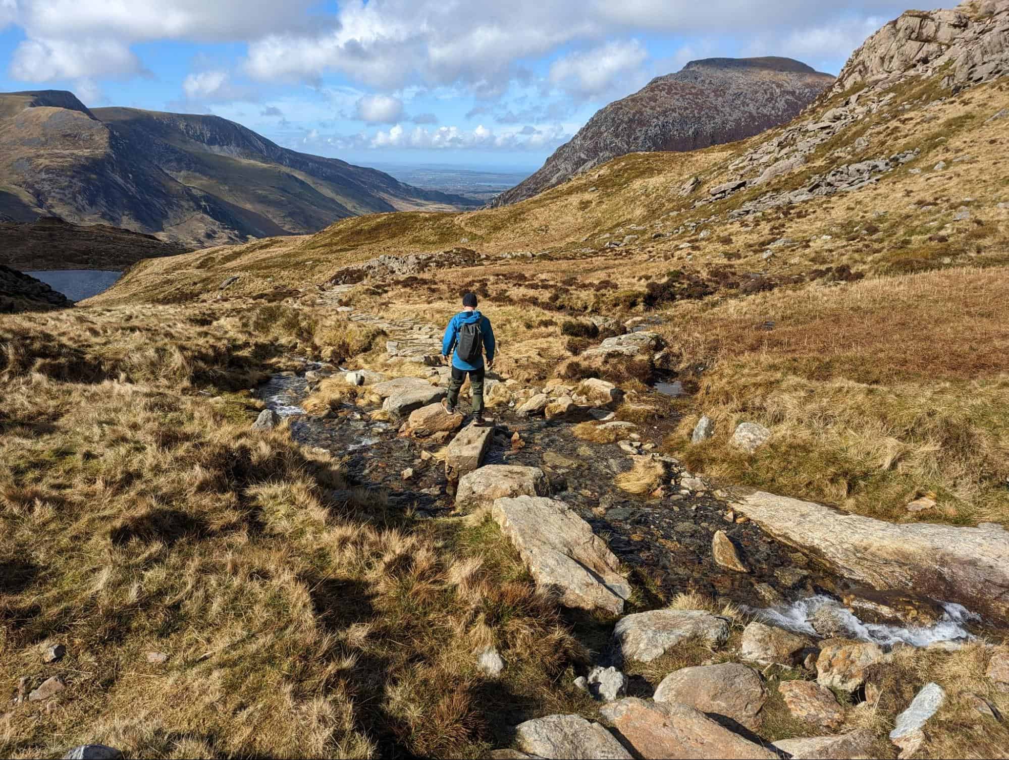 Crossing a stream on the way down from Tryfan’s mountain peak in Snowdonia. (photo: Steve Cleverdon)