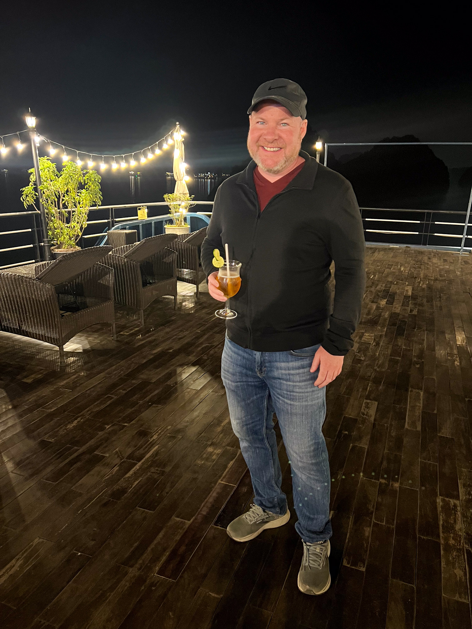 Dave with a drink in hand on the rooftop deck of Rosy Cruise ship