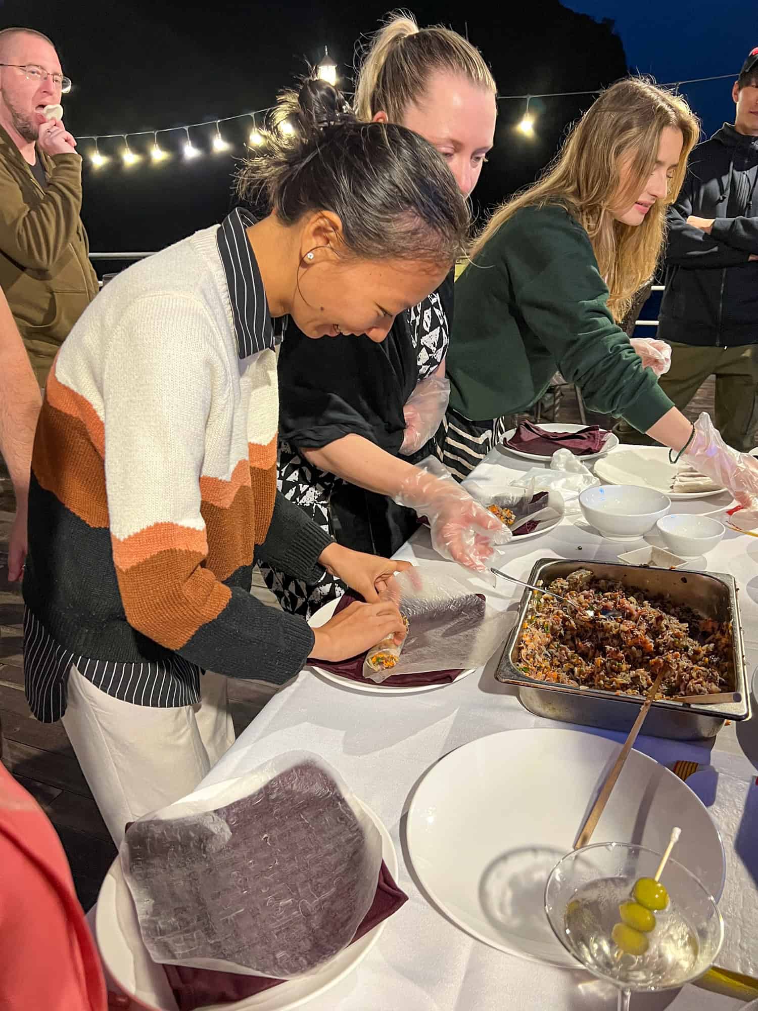 Guests preparing Vietnamese spring rolls before dinner.