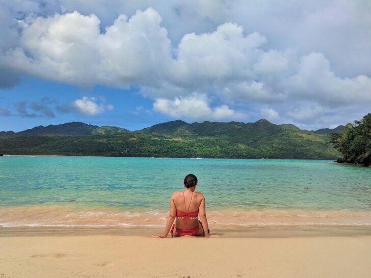 Woman sitting on the beach in Las Galeras, Dominican Republic (photo: Michael Baron)