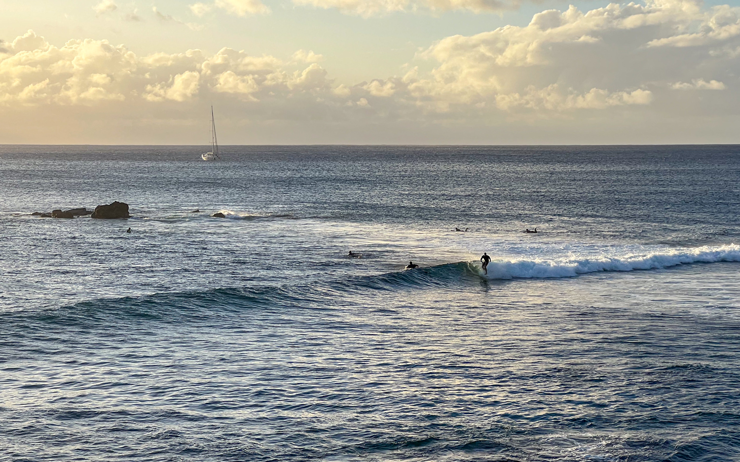 Surfers at sunset on Easter Island.