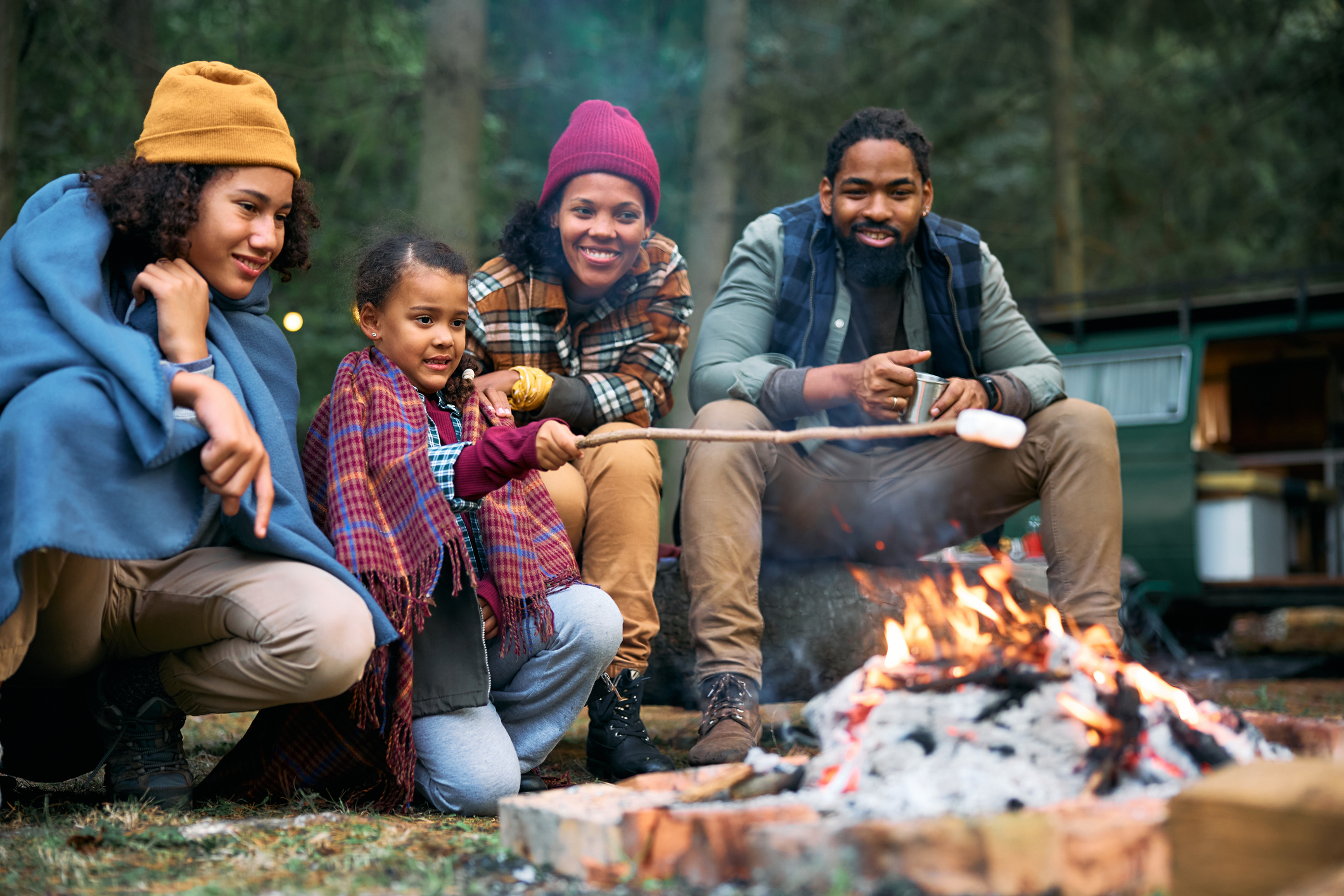 A girl roasting a marshmallow over a campfire (photo: Drazen Zigic, iStock license)