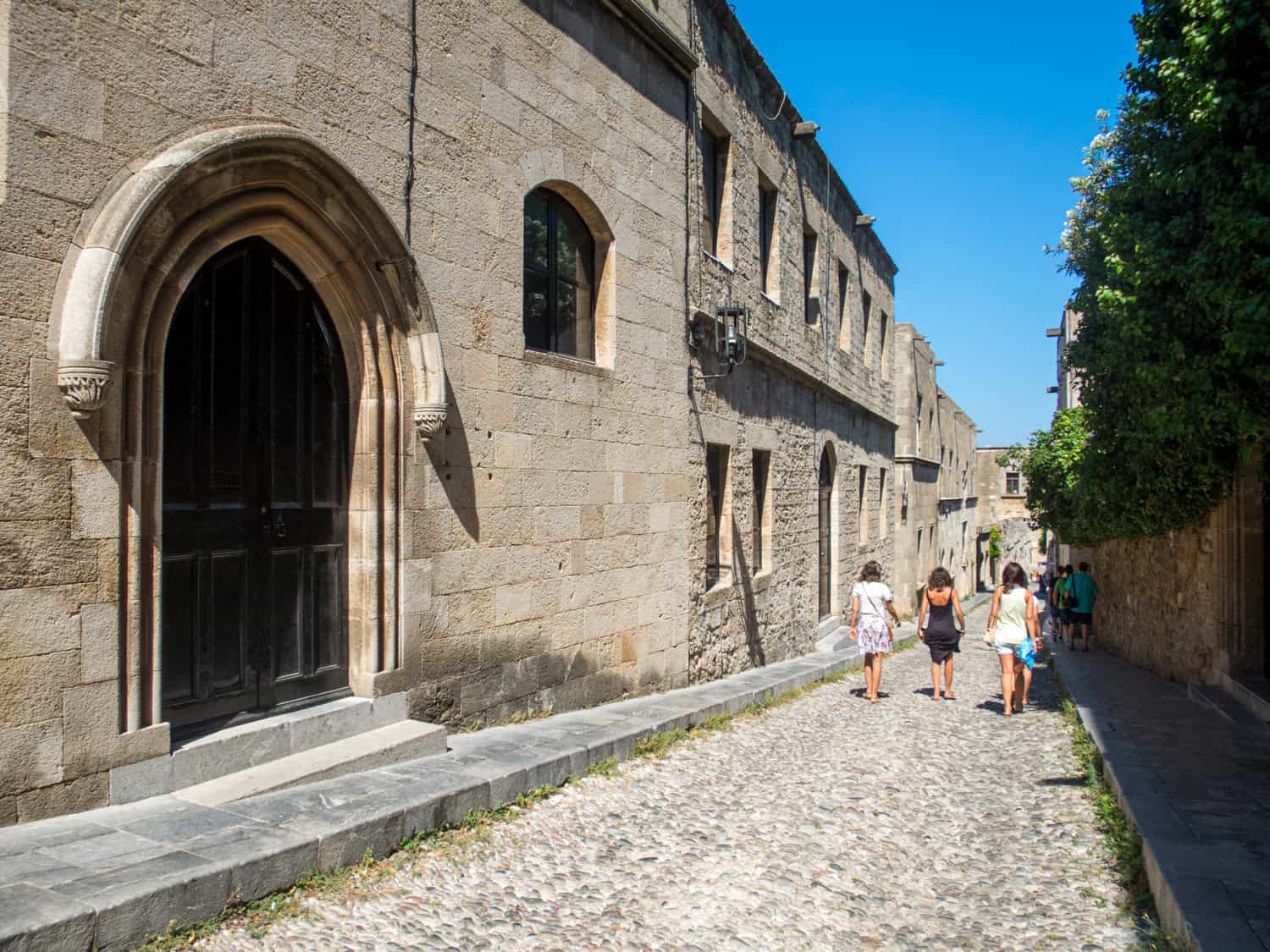 Tourists walking through the Medieval City of Rhodes, Greece.