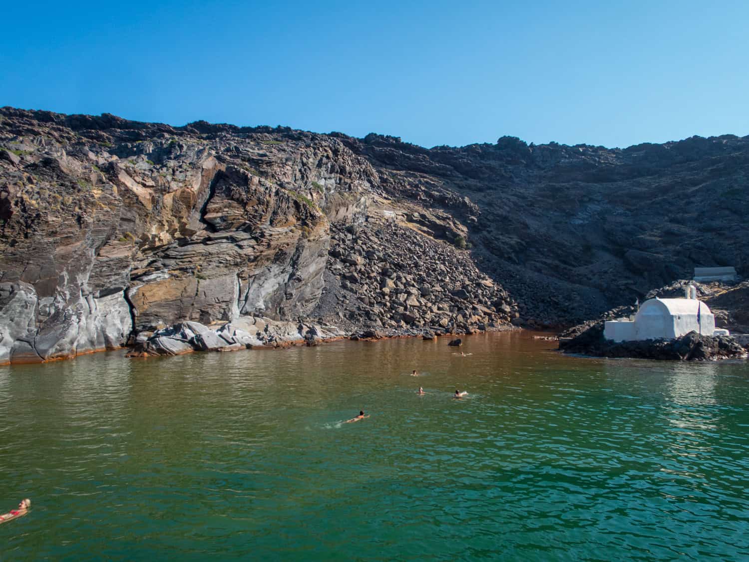 The Hot Springs at Palea Kameni are a popular swimming spot for Santorini sunset cruises.
