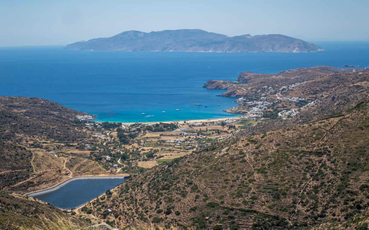 Driving toward Mylopotas Beach on Ios. Sikinos Island is in the background.